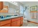 Well-maintained bathroom with wood vanity, a large mirror, and decorative accents at 4365 Canal Rd, Lake Wales, FL 33898