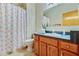 Bathroom with a vanity and cabinet, featuring shower curtain and decorative accents at 4365 Canal Rd, Lake Wales, FL 33898