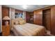 Comfortable bedroom featuring natural light, wood paneled walls, and closet space at 4365 Canal Rd, Lake Wales, FL 33898