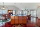 Open dining room with hardwood floors, large windows, and a center island with additional storage at 4365 Canal Rd, Lake Wales, FL 33898