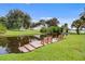Wooden dock with built-in benches overlooking the tranquil waterfront and picturesque landscape at 4365 Canal Rd, Lake Wales, FL 33898