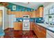 Bright kitchen featuring wood cabinets, modern appliances, and a large window for plenty of natural light at 4365 Canal Rd, Lake Wales, FL 33898