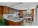 Efficient kitchen with wood cabinetry, classic appliances, and adjacent dining area at 4365 Canal Rd, Lake Wales, FL 33898