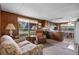Comfortable living room open to the kitchen area with wood-paneled walls and ample seating at 4365 Canal Rd, Lake Wales, FL 33898