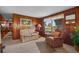 Cozy living room with wood paneled walls, neutral carpet and natural light at 4365 Canal Rd, Lake Wales, FL 33898