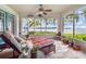 Relaxing screened-in porch with lake views, comfortable seating, and potted plants at 4365 Canal Rd, Lake Wales, FL 33898