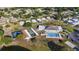 Aerial view of community amenities featuring a swimming pool, tennis courts, and lush landscaping at 4940 Foxdale Dr, Lakeland, FL 33810