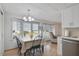 Bright dining area with a chandelier, complemented by views from large windows, enhancing the dining experience at 4940 Foxdale Dr, Lakeland, FL 33810