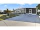 Inviting single-story home featuring a cozy screened-in porch, a well-manicured lawn, and convenient driveway parking at 4940 Foxdale Dr, Lakeland, FL 33810