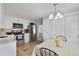 Charming eat-in kitchen with stainless steel appliances, white cabinets, and a cozy dining area for casual meals at 4940 Foxdale Dr, Lakeland, FL 33810