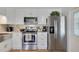 Modern kitchen featuring stainless steel appliances, white cabinetry, and stylish backsplash, designed for culinary enthusiasts at 4940 Foxdale Dr, Lakeland, FL 33810
