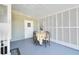 Charming patio area with lattice design, table, four chairs, and a cheerful welcome mat at 4940 Foxdale Dr, Lakeland, FL 33810