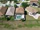 Aerial view of a home with a screened-in pool and patio in a well-maintained neighborhood at 4962 Sweet Cedar Cir, Orlando, FL 32829
