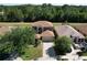 Spacious home with a lush green lawn and mature trees on a sunny day at 4962 Sweet Cedar Cir, Orlando, FL 32829
