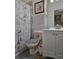 Cozy bathroom with a Paris themed shower curtain, white vanity, and decorative accents at 4962 Sweet Cedar Cir, Orlando, FL 32829