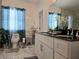 Elegant bathroom with marble tile, black countertop, and a glass shower door at 4962 Sweet Cedar Cir, Orlando, FL 32829