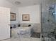 Bright bathroom showcasing a marble-clad tub and glass-enclosed shower area at 4962 Sweet Cedar Cir, Orlando, FL 32829