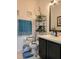 Bathroom featuring a single sink, framed mirror, decorative plants, a grab bar, and framed pictures on the wall at 4962 Sweet Cedar Cir, Orlando, FL 32829