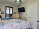 Cozy bedroom featuring a ceiling fan, closet, window with dark shutters, and neutral wall color at 4962 Sweet Cedar Cir, Orlando, FL 32829