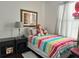 Bright bedroom showcasing a comfortable twin bed, a decorative headboard, and a soft area rug at 4962 Sweet Cedar Cir, Orlando, FL 32829