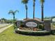 Community entrance sign for Bella Vista at Tivoli Woods surrounded by lush landscaping and palm trees at 4962 Sweet Cedar Cir, Orlando, FL 32829