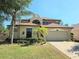 Charming two-story home featuring a two-car garage, manicured lawn, and inviting curb appeal at 4962 Sweet Cedar Cir, Orlando, FL 32829
