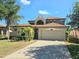 Charming two-story home featuring a two-car garage, manicured lawn, and inviting curb appeal at 4962 Sweet Cedar Cir, Orlando, FL 32829