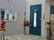 Charming turquoise front door with wreath, sidelight window and stylish decor at 4962 Sweet Cedar Cir, Orlando, FL 32829