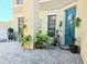 Inviting front entrance with a blue door, decorative plants, and a charming walkway at 4962 Sweet Cedar Cir, Orlando, FL 32829