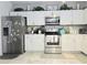 Bright kitchen with white cabinets, stainless steel appliances, and modern countertops at 4962 Sweet Cedar Cir, Orlando, FL 32829