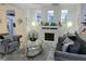 Elegant living room with a fireplace, neutral colors, a glass coffee table, and stylish decor at 4962 Sweet Cedar Cir, Orlando, FL 32829