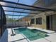 Covered in-ground pool featuring a screened enclosure with lounge area and decorative tiled coping at 4962 Sweet Cedar Cir, Orlando, FL 32829