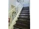Bright staircase featuring wood treads, mosaic tile risers, and a white decorative railing at 4962 Sweet Cedar Cir, Orlando, FL 32829