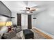 Cozy room showcasing a ceiling fan, window with curtains, and a comfortable seating area at 501 Main St, Lake Hamilton, FL 33851