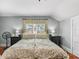 Bright bedroom with a decorative bed frame, hardwood floors, and modern lighting at 501 Main St, Lake Hamilton, FL 33851