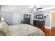 Cozy bedroom featuring hardwood floors, a ceiling fan, and dark wood furniture at 501 Main St, Lake Hamilton, FL 33851