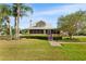 Charming two-story home with a well-maintained lawn, mature trees, and inviting front porch at 501 Main St, Lake Hamilton, FL 33851