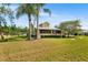 Well-maintained two-story home with mature trees, a green lawn, and a classic facade at 501 Main St, Lake Hamilton, FL 33851