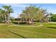 Picturesque home with a lush lawn, mature trees, and a charming walkway leading to the entrance at 501 Main St, Lake Hamilton, FL 33851