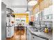 Bright kitchen featuring granite counters, stainless appliances, and charming yellow accents at 501 Main St, Lake Hamilton, FL 33851