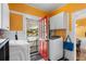 Bright laundry room featuring a washing machine, dryer, and access to the outdoors at 501 Main St, Lake Hamilton, FL 33851
