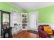 Bright living room featuring hardwood floors, a white bookshelf, and a comfortable-looking leather chair at 501 Main St, Lake Hamilton, FL 33851