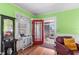 Bright living room with hardwood floors, colorful walls, and access to an inviting sunroom at 501 Main St, Lake Hamilton, FL 33851