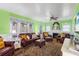 Cozy living room with a fireplace, leather seating, wood flooring, and a decorative area rug at 501 Main St, Lake Hamilton, FL 33851