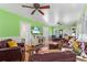 Comfortable living room featuring leather furniture, wood floors, bright walls, and a modern entertainment center at 501 Main St, Lake Hamilton, FL 33851