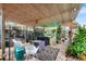 Outdoor patio with a covered seating area, featuring a bamboo roof and outdoor furnishings at 501 Main St, Lake Hamilton, FL 33851