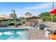 Backyard pool and patio area with ample seating, surrounded by a well-maintained garden at 501 Main St, Lake Hamilton, FL 33851