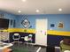 Finished basement with sports decor, two-tone walls, and seating area at 501 Main St, Lake Hamilton, FL 33851