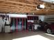 Well-organized garage with exposed rafters, storage cabinets, and workspace at 501 Main St, Lake Hamilton, FL 33851