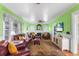 Cozy living room with a fireplace, ceiling fan, and hardwood floors at 501 Main St, Lake Hamilton, FL 33851